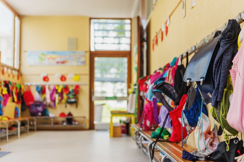 School cloakroom showing bags hanging on pegs