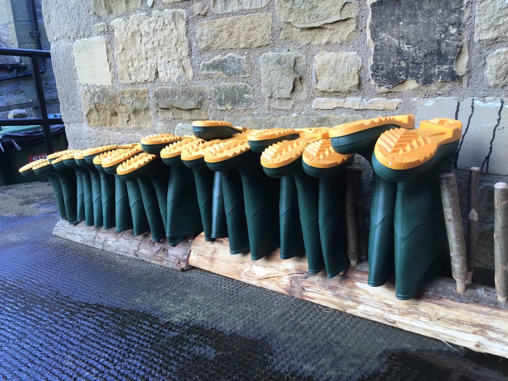 Child's wellies lined up on a wall